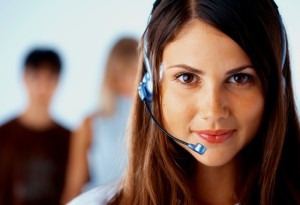 Young beautiful woman with headset with some people at the background